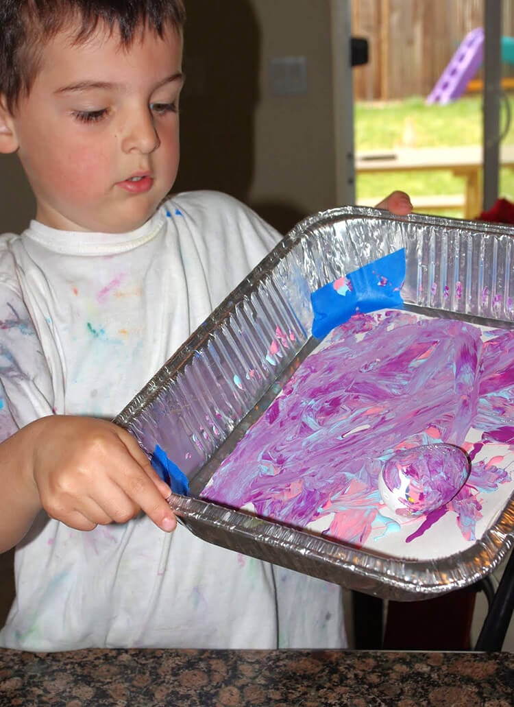 kids playing with marble painting on easter eggs