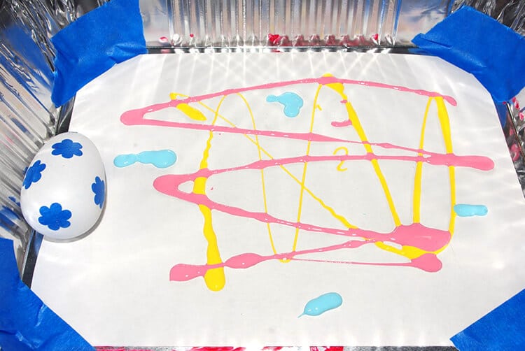 rolling marbles to paint wooden easter eggs