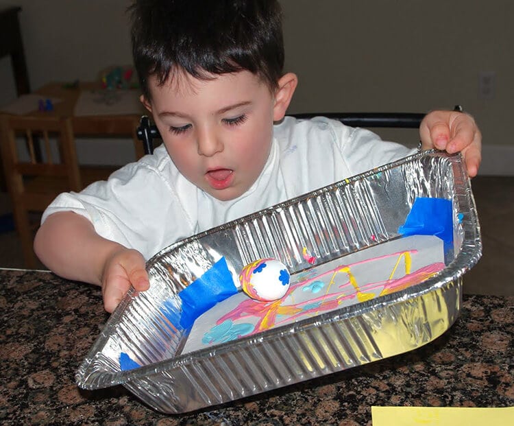 kids having fun painting with marbles