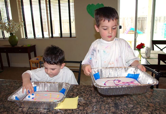 kids rolling marbles with easter eggs