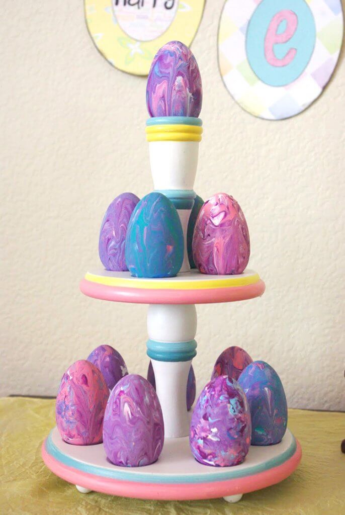 marbled painted wooden easter eggs on a cake tier 