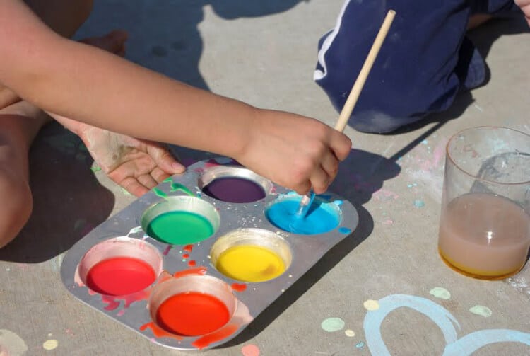 child painting with diy sidewalk chalk paint