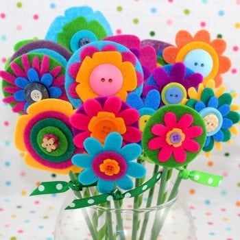 buttons and stems added to flowers and placed in vase