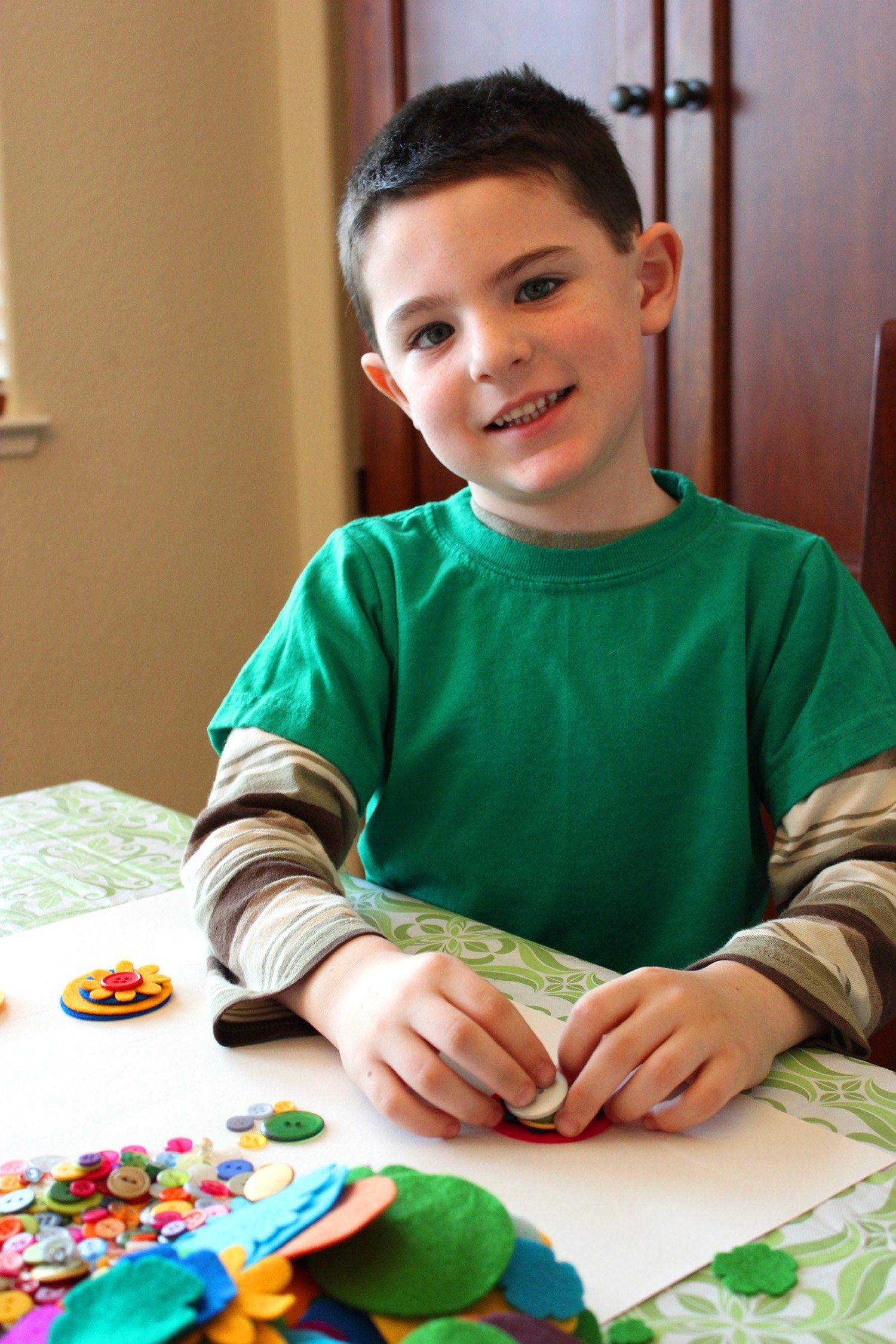 cute kid assembling felt flowers