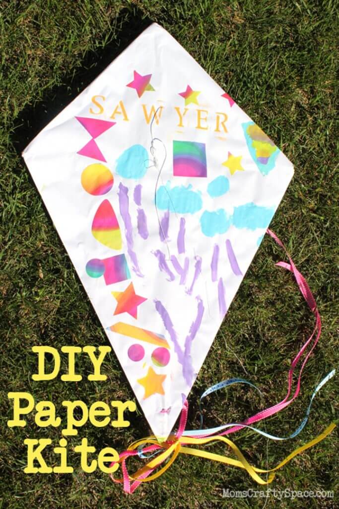 DIY paper kite decorated and laying on lawn