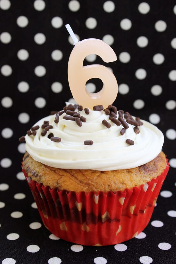 chocolate vanilla swirled cupcake with cupcake topper that reads '6'