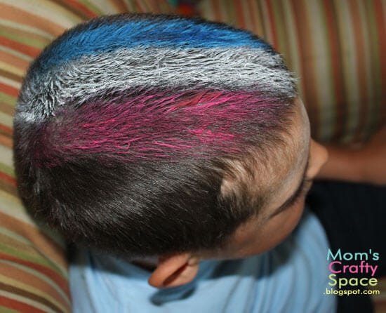 small boy with red white and blue painted hair 