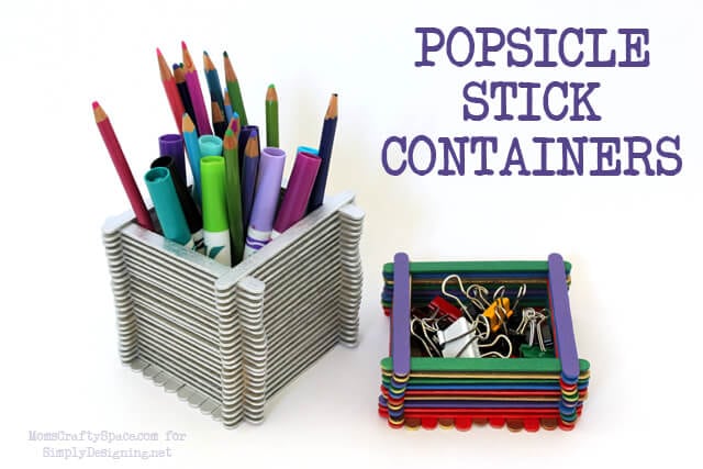 popsicle stick craft on desk with office supplies