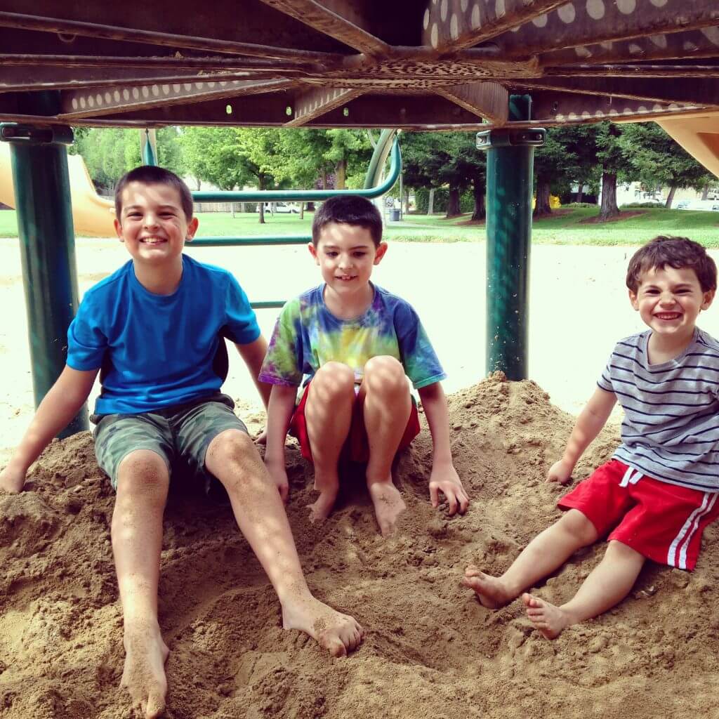 kids smiling at outdoor play area