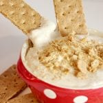 caramel cheesecake dip with graham crackers in bowl