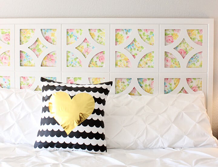 diy headboard with vintage sheets and cut it out frames slider and heart pillow on bed