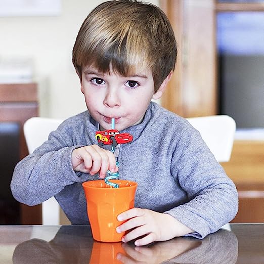 Cars crazy straw being used by small boy drinking out of cup