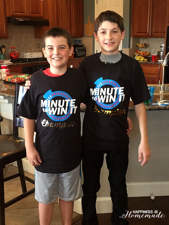 "Minute to Win It Champion" shirts on the two winning boys