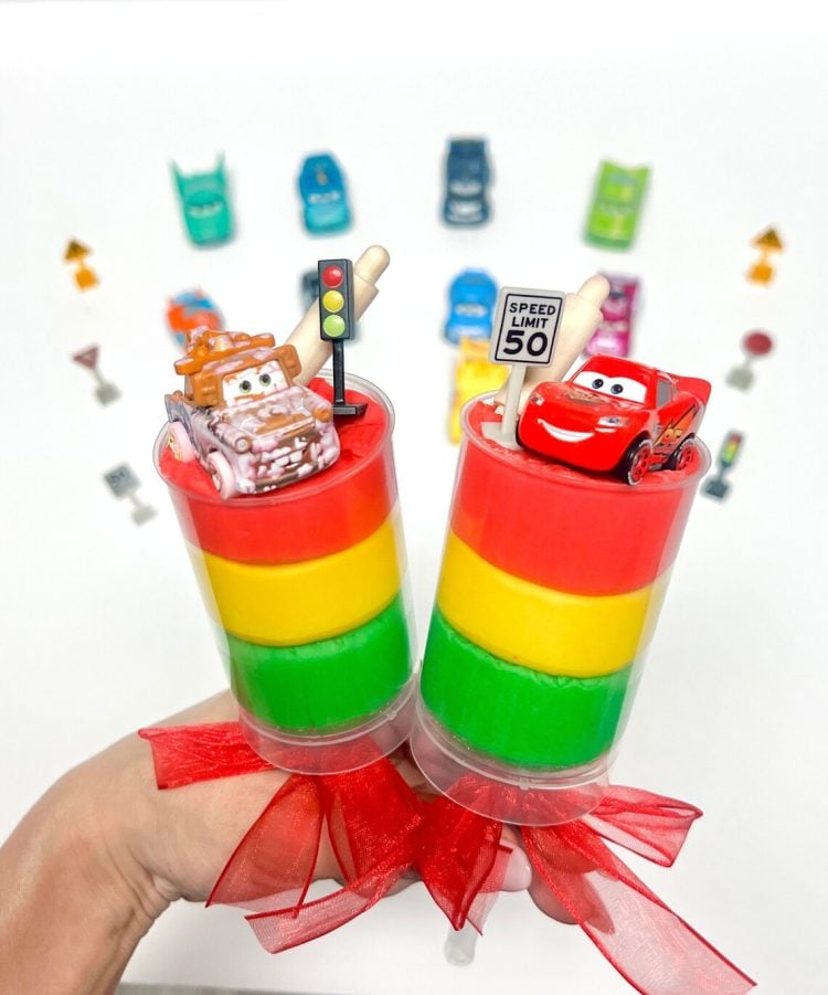 custom cars playdough party favors displayed with car toys in background
