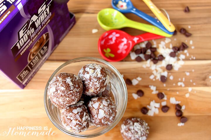 yummy homemade protein bites in mason jar with measuring spoons nearby