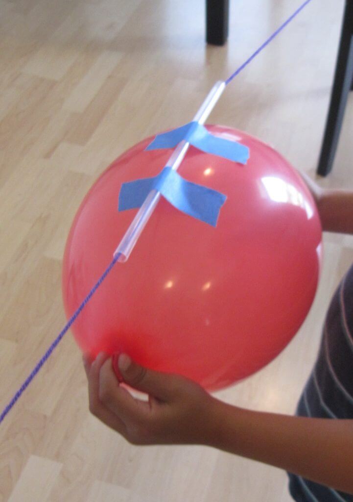 balloon rockets held by kid