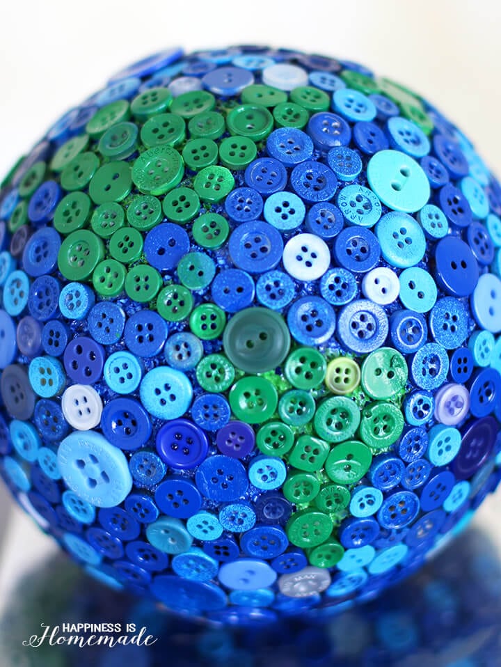 globe covered in blue and green buttons 