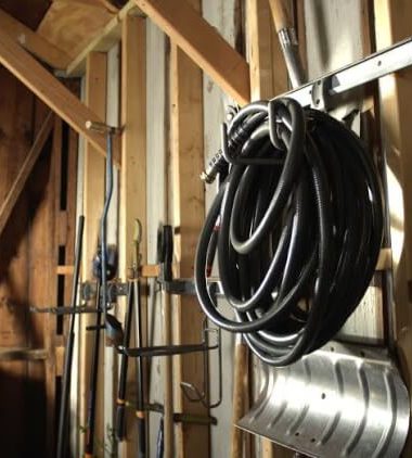 tools and hoses organized in tool shed