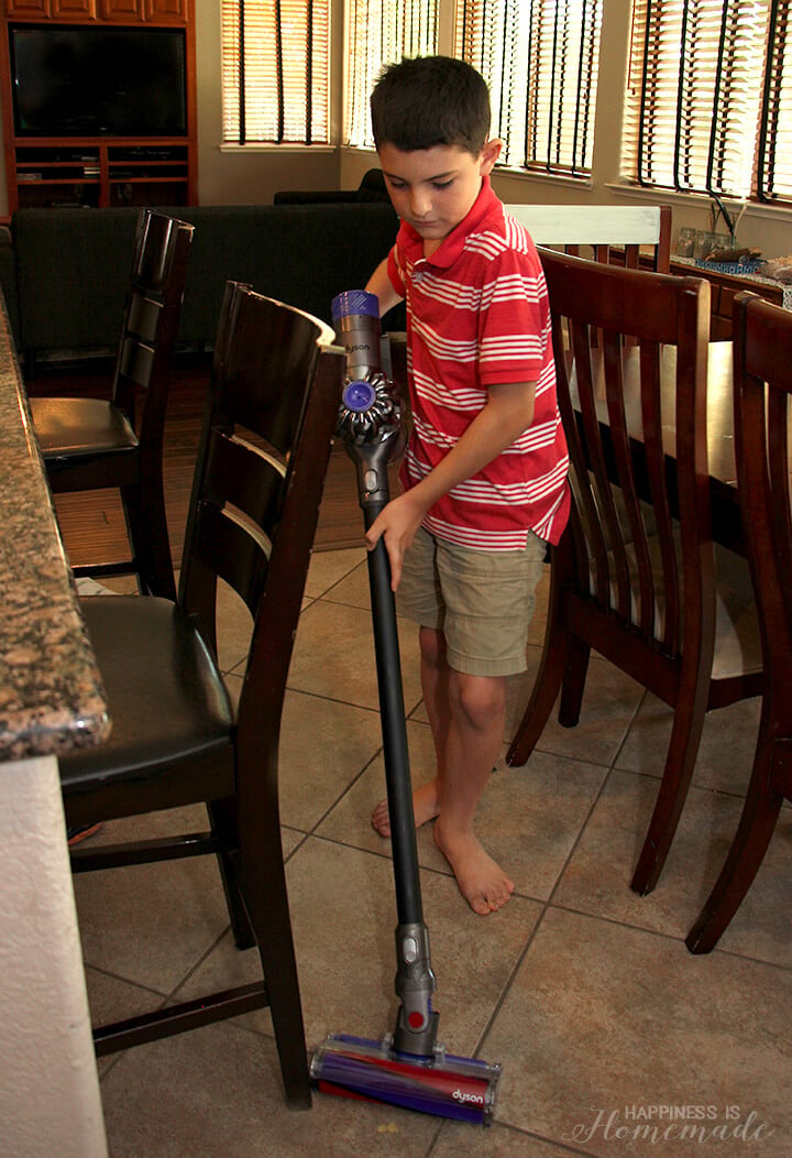 child vacuuming kitchen floors