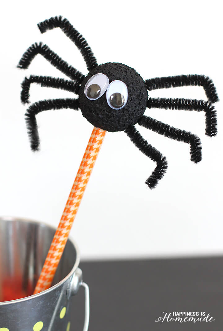 spider with googly eyes on pen