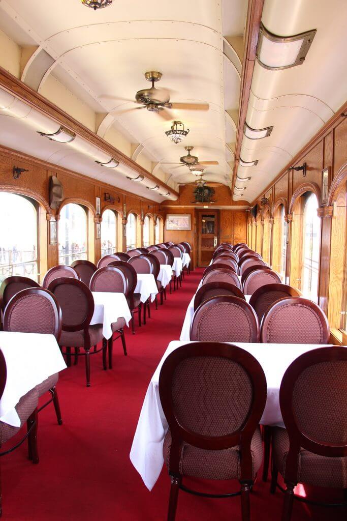 dining tables set up inside of wine train