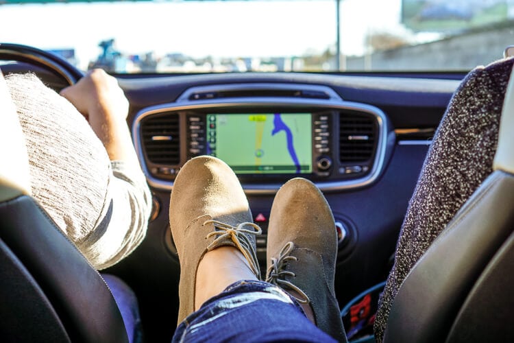 feet up in kia with navigation in background