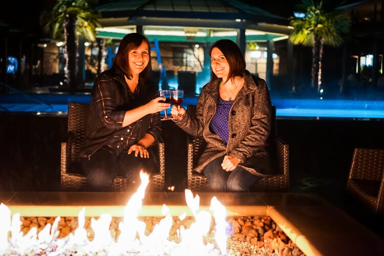 ladies enjoying cocktails by the fire pit 