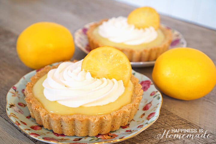 meyer lemon tart topped with whipped cream and candied lemons