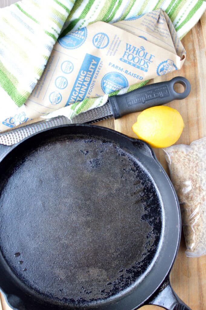 skillet, knife, lemon and various ingredients to make haddock