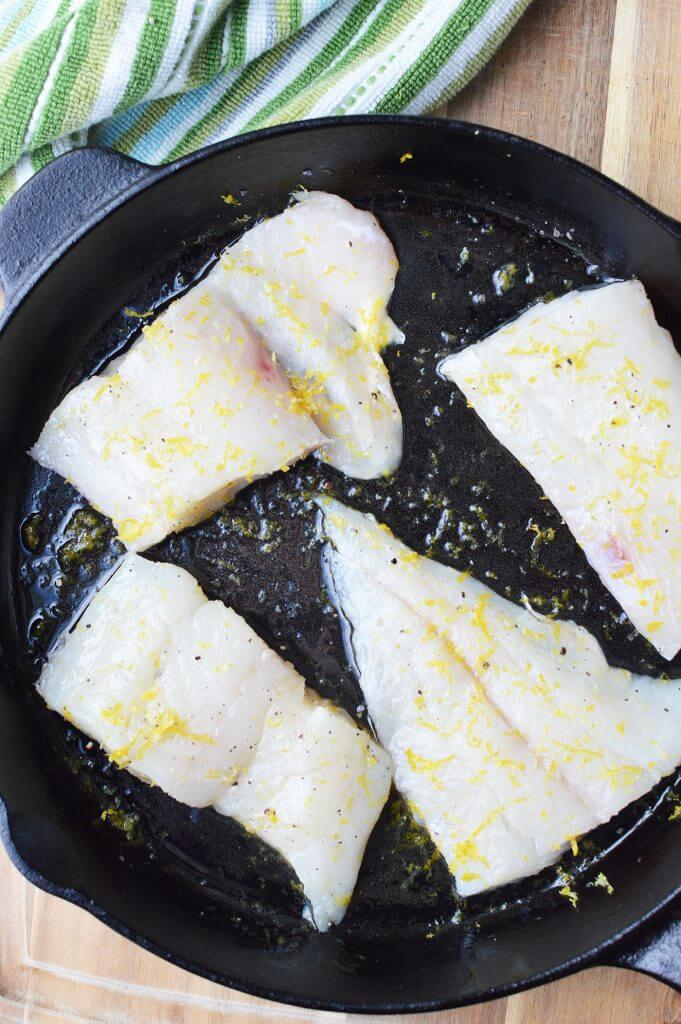 haddock slices placed into skillet cooking