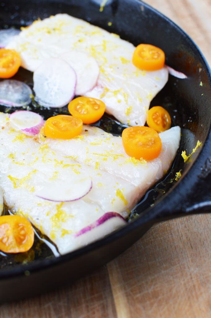 haddock prepared in skillet with roasted veggies