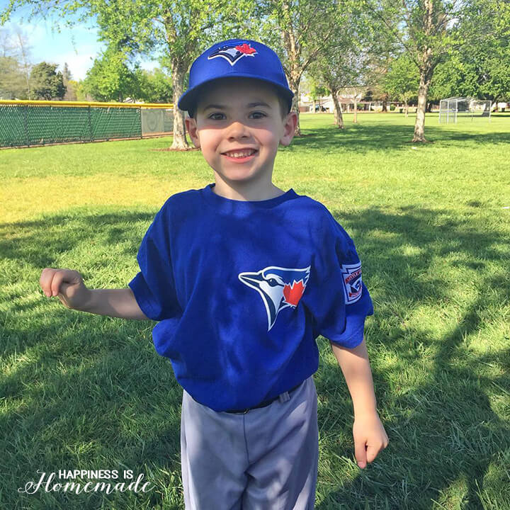 sweet smiling boy ready to play baseball in baseball uniform