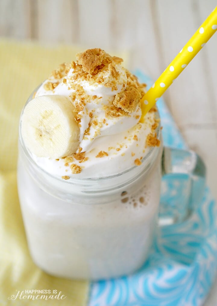 a banana smoothie in a mason jar with a yellow straw