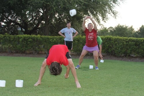 kids playing outdoor toilet paper tossing game