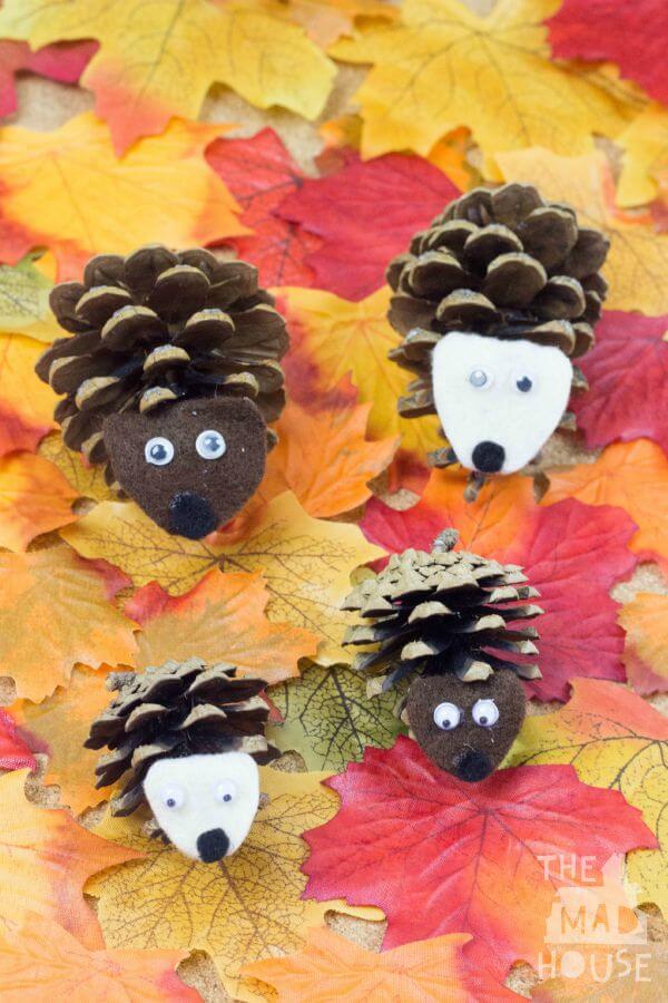 hedgehogs made from pine cones on fall leaves