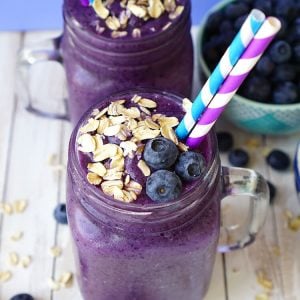 healthy blueberry muffin smoothies in mason jars with straws and toppings