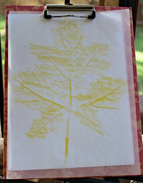 leaf rub on paper done with yellow crayon