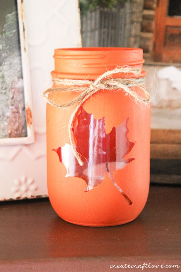 mason jar fall leaf luminary next to photo frames