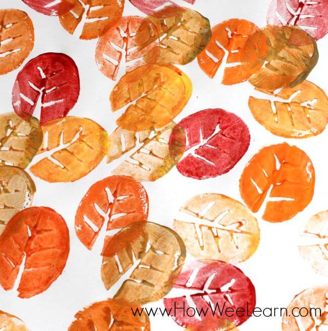 autumn leaves stamped all over paper using potatos as stamp