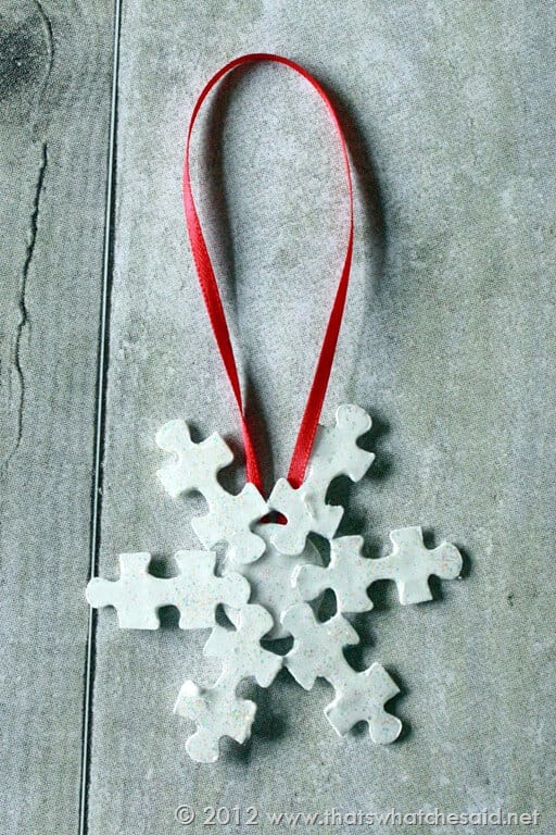 puzzle pieces made into a snowflake christmas ornament