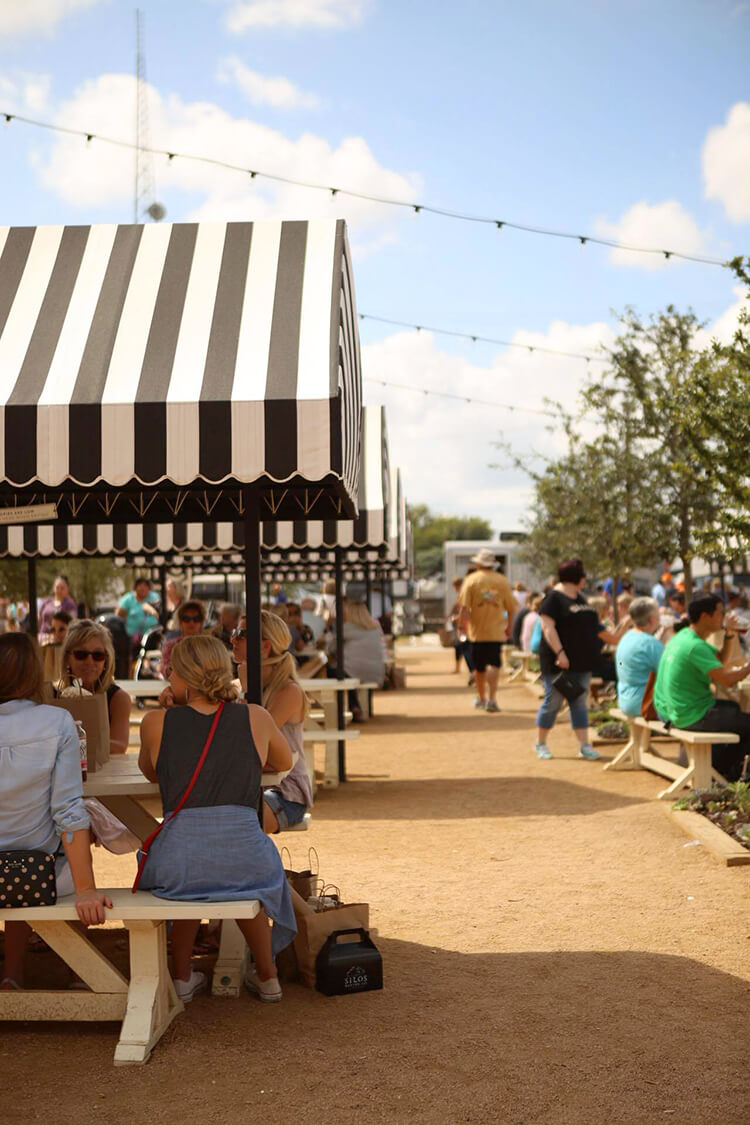 people dining at magnolia market outdoor seating area