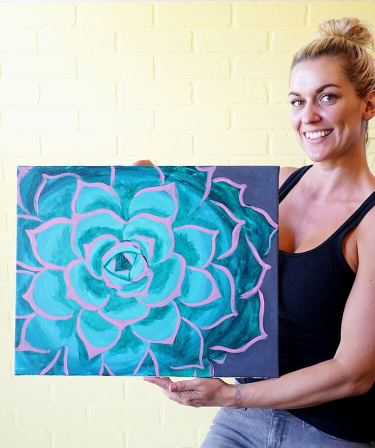 lovely lady holding up her finished succulent painting
