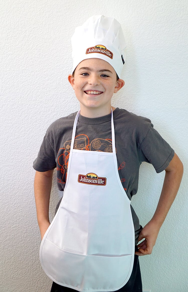 smiling boy in chefs hat and apron
