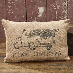 truck with christmas tree in bed pillow that reads merry christmas