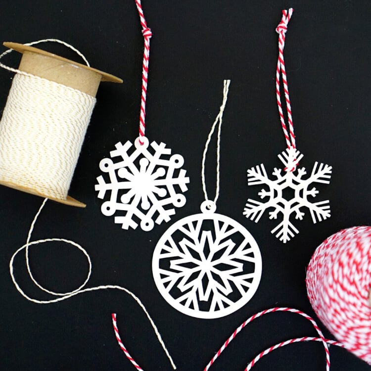 spool of string and laser cut ornaments that have been strung