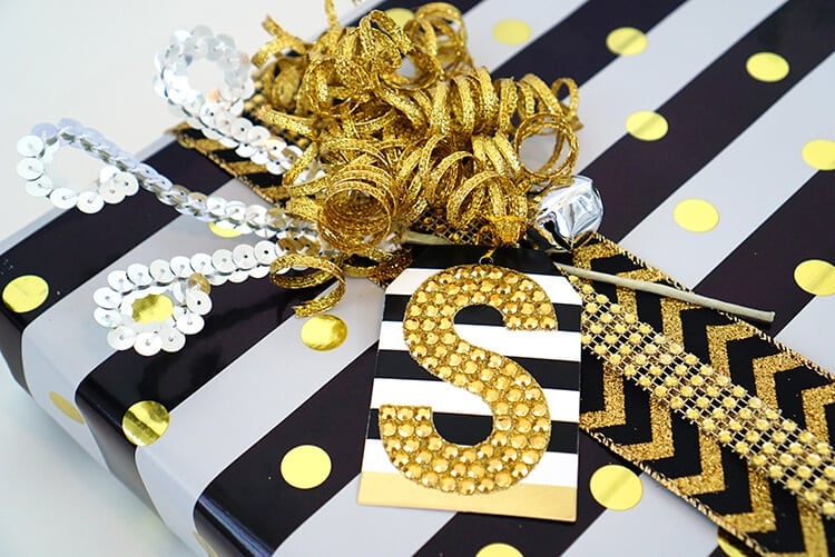 gold, white and black gift with a large S gift tag