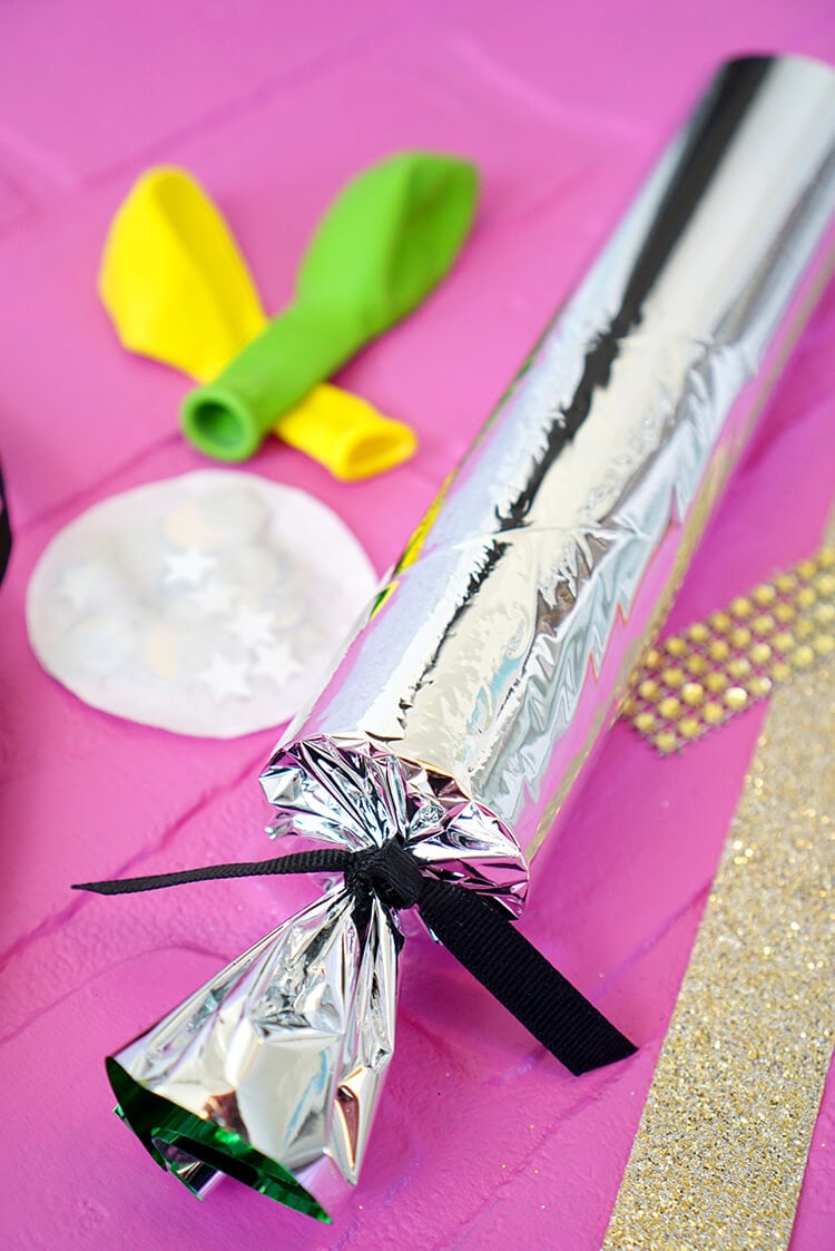 foil folded around paper tube with ends tied