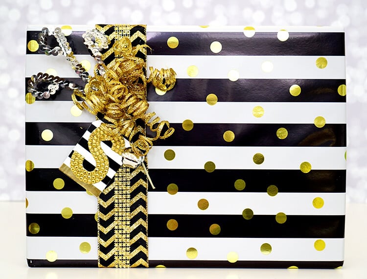 gold, white and black gift with a large S gift tag
