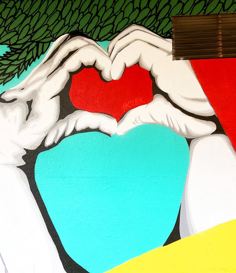 Galveston Mural of hands holding up a heart symbol