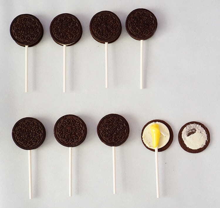 oreo pops being made with sticks placed between two sides of oreos